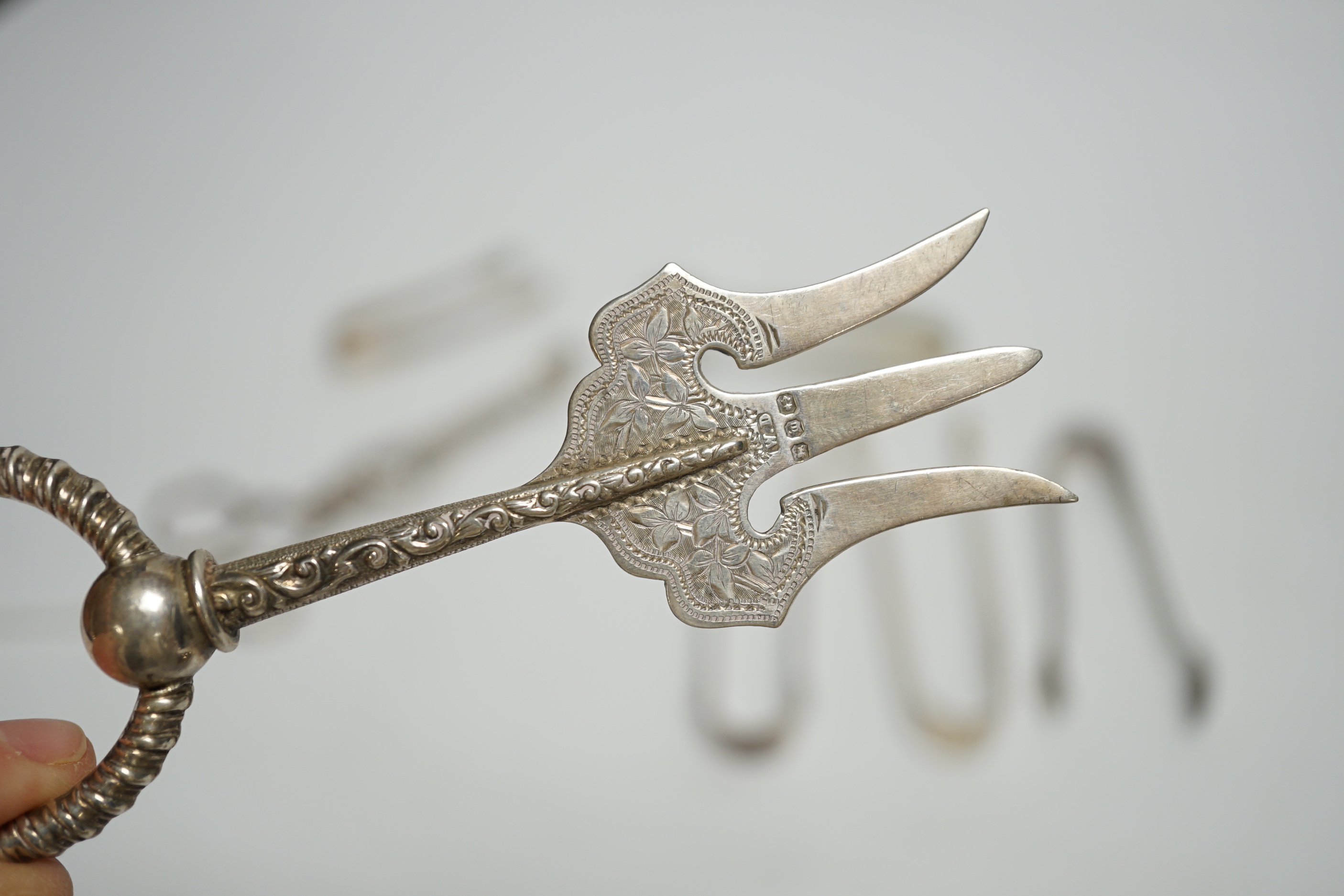 A pair of 18th century Irish silver sugar nips, together with sixteen later mainly 20th century silver sugar nips, various dates and makers, eight plated pairs and a small silver toasting? fork.